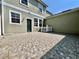 A spacious outdoor patio area with tiled flooring, complemented by green exterior wall and white trim at 7128 Five Oaks Dr, Harmony, FL 34773