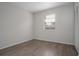 Simple bedroom featuring wood-look floors and a window at 1209 Baranova Rd, Ocoee, FL 34761