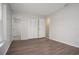 Bright bedroom with wood-look floors and an adjacent bathroom at 1209 Baranova Rd, Ocoee, FL 34761