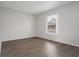 Simple bedroom with wood-look flooring and a large window at 1209 Baranova Rd, Ocoee, FL 34761
