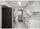 Modern kitchen with white cabinets, stainless steel appliances, and quartz countertops at 1209 Baranova Rd, Ocoee, FL 34761