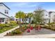 Neatly landscaped front yard with red chairs and palm trees at 13104 Markowitz Aly, Orlando, FL 32827