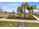 Landscaped front yard with palm trees and seating area at 13104 Markowitz Aly, Orlando, FL 32827