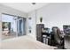 Bright home office with large window, desk, and view of patio at 13104 Markowitz Aly, Orlando, FL 32827