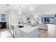Modern kitchen with white cabinets, island, and stainless steel appliances at 13104 Markowitz Aly, Orlando, FL 32827