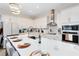Modern kitchen with white cabinets, large island, and breakfast bar at 13104 Markowitz Aly, Orlando, FL 32827