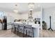 Modern kitchen with white cabinets, large island, and breakfast bar at 13104 Markowitz Aly, Orlando, FL 32827