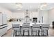 Modern kitchen with white cabinets, large island, and breakfast bar at 13104 Markowitz Aly, Orlando, FL 32827