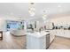 Modern kitchen with white cabinets, island, and stainless steel appliances at 13104 Markowitz Aly, Orlando, FL 32827