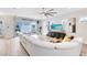 Spacious living room featuring a white sectional sofa and a large TV at 13104 Markowitz Aly, Orlando, FL 32827