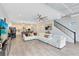 Open living space with sectional sofa, kitchen view, and modern decor at 13104 Markowitz Aly, Orlando, FL 32827