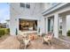 Relaxing patio with string lights, comfortable seating, and view into the home at 13104 Markowitz Aly, Orlando, FL 32827