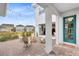 Covered patio with string lights and seating area, showcasing teal door at 13104 Markowitz Aly, Orlando, FL 32827