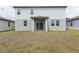 The backyard features a covered patio with sliding glass doors and a well-manicured lawn at 2949 Wild Olive Dr, St Cloud, FL 34772