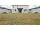 View of the home's backyard featuring the exterior and covered patio with sliding glass door at 2949 Wild Olive Dr, St Cloud, FL 34772