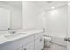 Bathroom featuring a shower-tub combo, modern vanity, and elegant fixtures at 2949 Wild Olive Dr, St Cloud, FL 34772