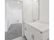 Modern bathroom featuring a white vanity with a sleek countertop and a large mirror at 2949 Wild Olive Dr, St Cloud, FL 34772