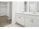 Bathroom featuring dual vanity sinks, modern tile floors, and walk-in closet at 2949 Wild Olive Dr, St Cloud, FL 34772