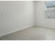 A clean and minimalist bedroom with neutral-toned tile floors and ample natural light at 2949 Wild Olive Dr, St Cloud, FL 34772