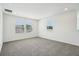 Bright bedroom featuring plush carpeting, ample natural light, and neutral paint colors at 2949 Wild Olive Dr, St Cloud, FL 34772