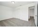 Bedroom features neutral carpet, closet, and a door leading to another room at 2949 Wild Olive Dr, St Cloud, FL 34772