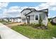 Beautifully designed home shows brick driveway, complemented by lush green lawn and vibrant plants at 2949 Wild Olive Dr, St Cloud, FL 34772