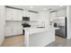 Modern kitchen with white cabinets, stainless steel appliances, and a center island at 2949 Wild Olive Dr, St Cloud, FL 34772