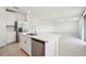 Bright, open kitchen with stainless steel appliances and an island that leads to living room at 2949 Wild Olive Dr, St Cloud, FL 34772