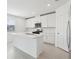 Bright kitchen boasts all-white cabinets, stainless appliances, an island with sink and plenty of counter seating at 2949 Wild Olive Dr, St Cloud, FL 34772