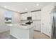 Well-lit kitchen featuring stainless steel appliances, white cabinetry, and a large island at 2949 Wild Olive Dr, St Cloud, FL 34772