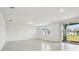 Bright, empty living room with tile floors and large sliding glass doors to the backyard at 2949 Wild Olive Dr, St Cloud, FL 34772