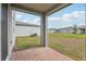 Covered patio with brick pavers and view of the spacious backyard and neighboring houses at 2949 Wild Olive Dr, St Cloud, FL 34772
