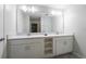 Elegant bathroom featuring double sinks, white cabinets, and a large mirror at 3171 Paradox Cir # 305, Kissimmee, FL 34746