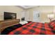 Spacious bedroom with a king-size bed, dresser, and en-suite bathroom at 3171 Paradox Cir # 305, Kissimmee, FL 34746
