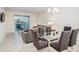 Dining area with glass table and gray velvet chairs at 3171 Paradox Cir # 305, Kissimmee, FL 34746