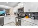 Modern kitchen with white cabinets and dark gray backsplash at 3171 Paradox Cir # 305, Kissimmee, FL 34746