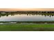 Serene lakefront view at sunset, showcasing a picturesque community at 3171 Paradox Cir # 305, Kissimmee, FL 34746