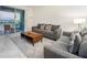 Living room with gray sectional and view to balcony at 3171 Paradox Cir # 305, Kissimmee, FL 34746