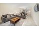 Living room with gray sectional sofa and wood coffee table at 3171 Paradox Cir # 305, Kissimmee, FL 34746