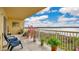Lovely balcony with a serene lake view, plants, and furniture for relaxation at 6336 Buford St # 705, Orlando, FL 32835