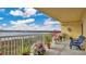 A spacious balcony offers water views, complete with decorative potted plants and comfortable chairs at 6336 Buford St # 705, Orlando, FL 32835