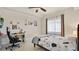 Bedroom with tile floors, bed, desk, and natural light coming in through window with curtains at 6336 Buford St # 705, Orlando, FL 32835