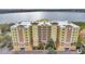Beautiful waterfront condominium featuring a large building with lovely landscaping at 6336 Buford St # 705, Orlando, FL 32835