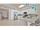 Modern kitchen with white cabinets, stainless steel appliances, granite counters, and a breakfast bar with seating at 6336 Buford St # 705, Orlando, FL 32835