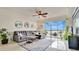 Inviting living room with a modern ceiling fan, decor, and a view of the water at 6336 Buford St # 705, Orlando, FL 32835