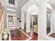 Elegant foyer featuring dark wood floors with bright trim, arched entryways, and a grand two-story entrance at 9168 Lake Avon Dr, Orlando, FL 32829