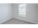 Bright bedroom featuring a window, white trim, and neutral carpeting at 1123 Union Ave, Mascotte, FL 34753