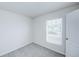 Cozy bedroom with a bright window, soft carpet, and fresh white walls at 1123 Union Ave, Mascotte, FL 34753