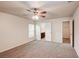 Cozy bedroom featuring neutral carpet, ceiling fan, and walk-in closet at 1123 Union Ave, Mascotte, FL 34753