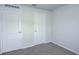 Clean bedroom featuring neutral carpet, white trim, and white doors at 1123 Union Ave, Mascotte, FL 34753
